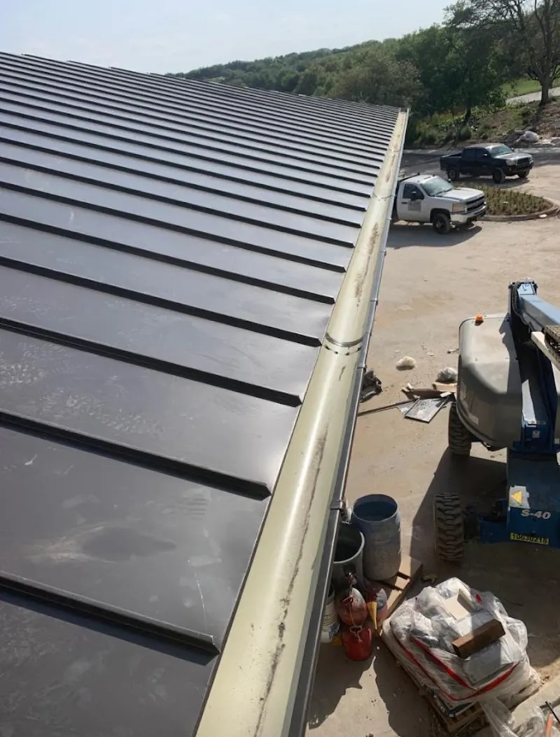 Standing seam panel and gutter detail on a metal roofing jobsite in Ste. Genevieve